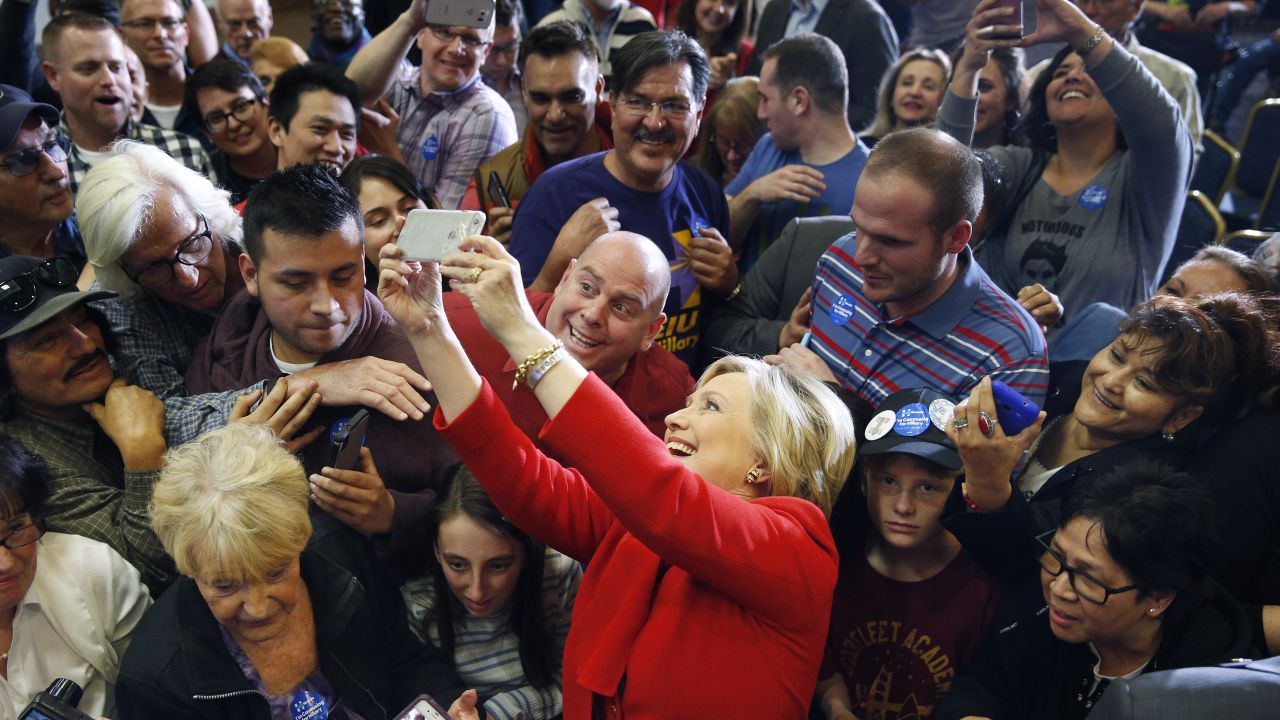 Democratic presidential candidate Hillary Clinton takes a selfie with supporters during a rally in Las Vegas on Sunday, February 14.