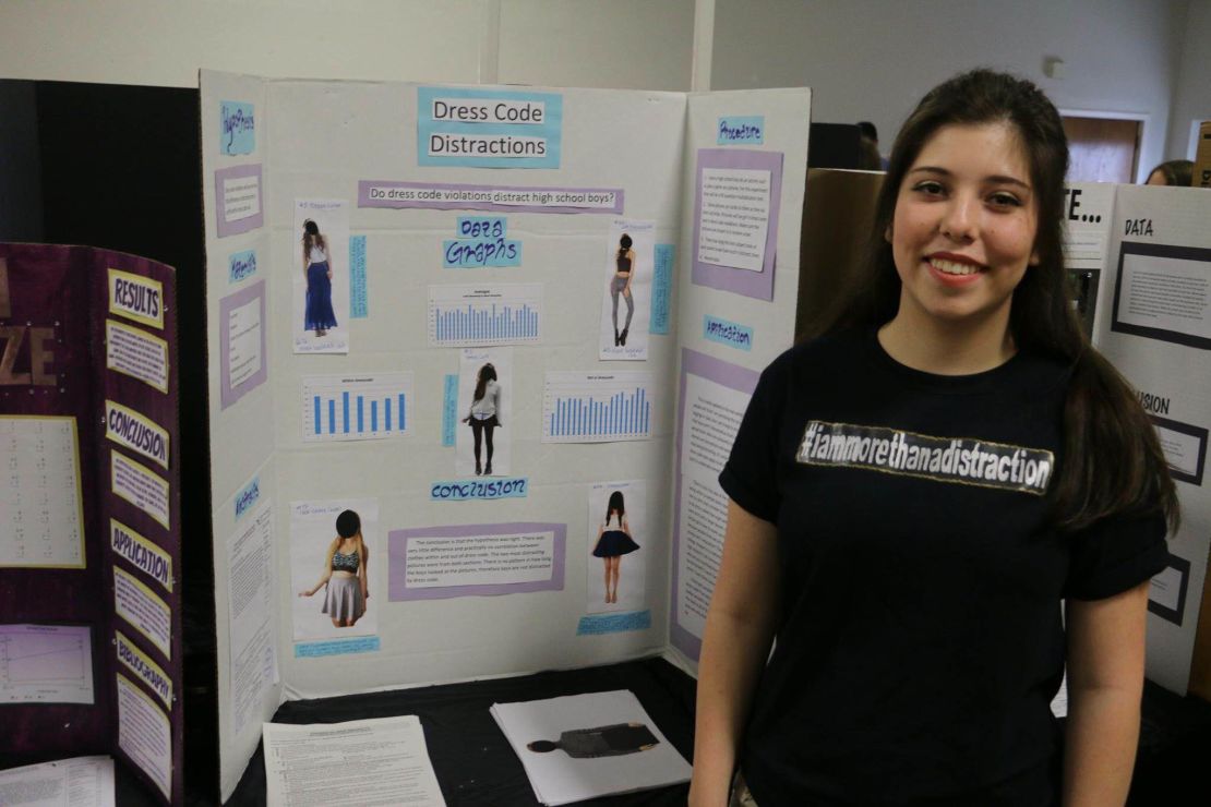Mari Tufts with her science project testing whether girls'  clothing is a distraction to boys. 