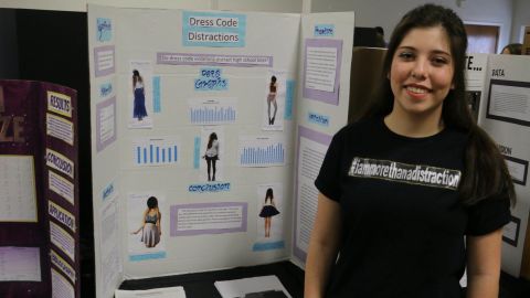 Mari Tufts with her science project testing whether girls' clothing is a distraction to boys.
