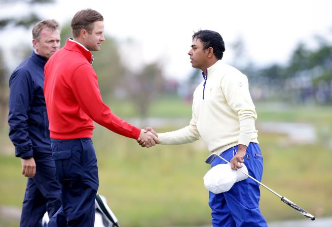 Lahiri, seen here shaking hands with Chris Kirk of the U.S. team, says participating in tournaments like the Presidents Cup in October, 2015 is a sign that his career is going in the right direction.