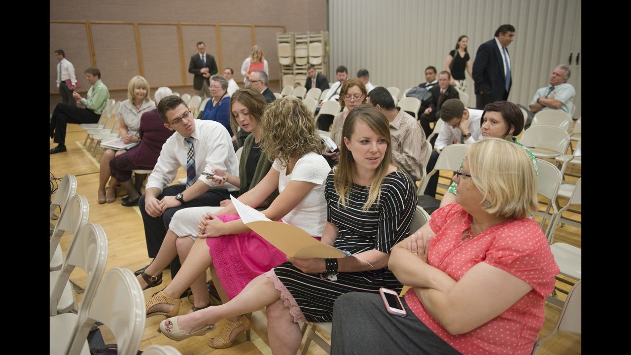 Klein, second from right, talks to another member of her church.