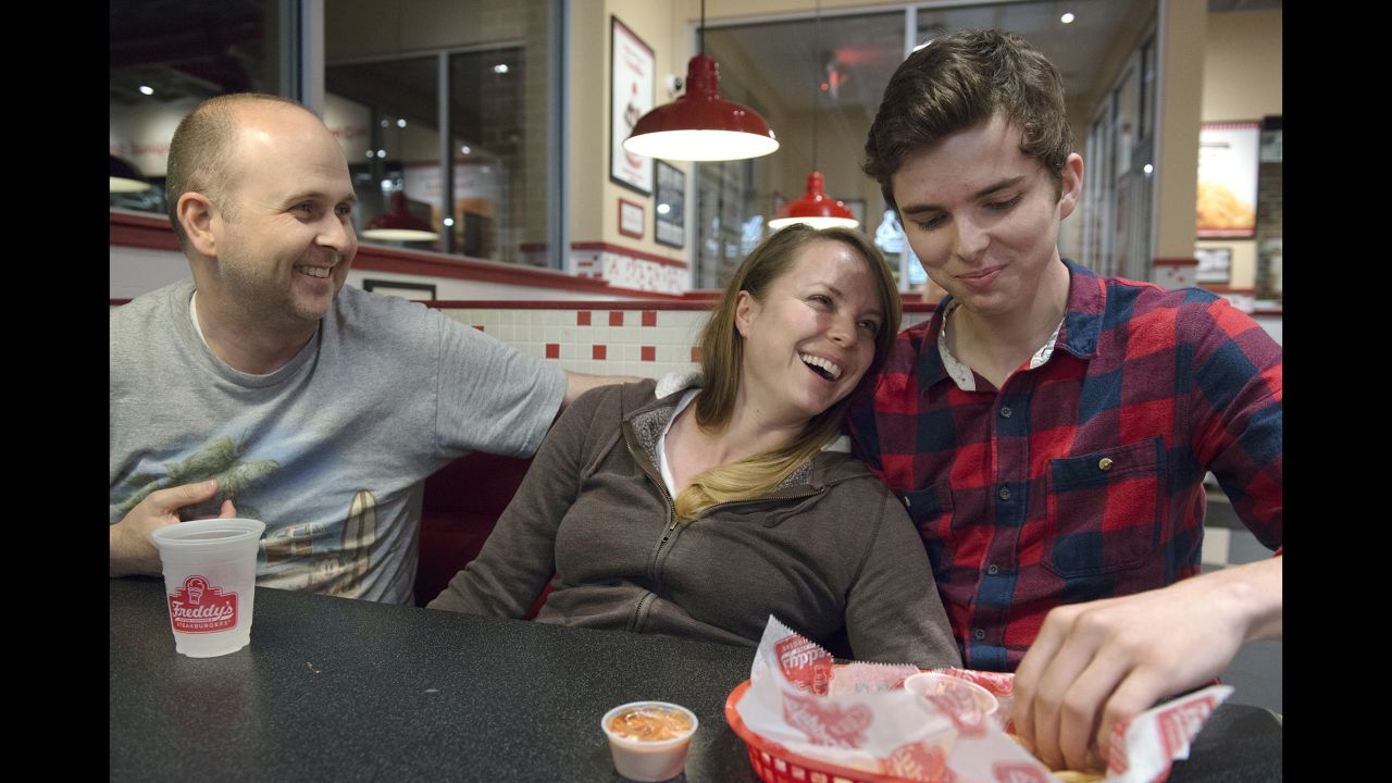 Klein and her husband joke with their son Grant at a local burger joint.