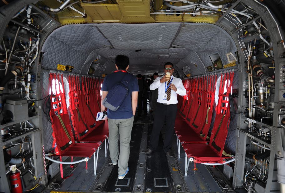 Visitors look at interior of a Boeing CH-47 Chinook helicopter on display by the Singapore Air Force during the Singapore Airshow on February 17.