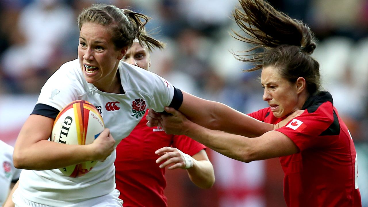 PARIS, FRANCE - AUGUST 17: Emily Scarratt of England breaks free from a tackle by Brittany Waters of Canada during the IRB Women's Rugby World Cup 2014 Final between England and Canada at Stade Jean-Bouin on August 17, 2014 in Paris, France. (Photo by Jordan Mansfield/Getty Images)
