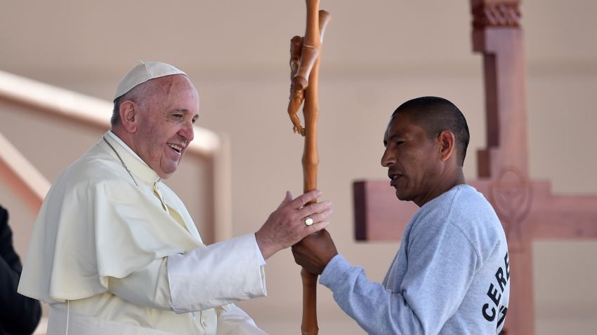 Pope Francis receives a cross made by an inmate at the CeReSo n. 3 prison in Ciudad Juarez, Mexico, Wednesday, Feb. 17, 2016. The pontiff is wrapping up his trip to Mexico on Wednesday with a visit in the prison, just days after a riot in another lockup killed 49 inmates, and a stop at the Texas border when immigration is a hot issue for the U.S. presidential campaign.  (Gabriel Bouys/Pool photo via AP)