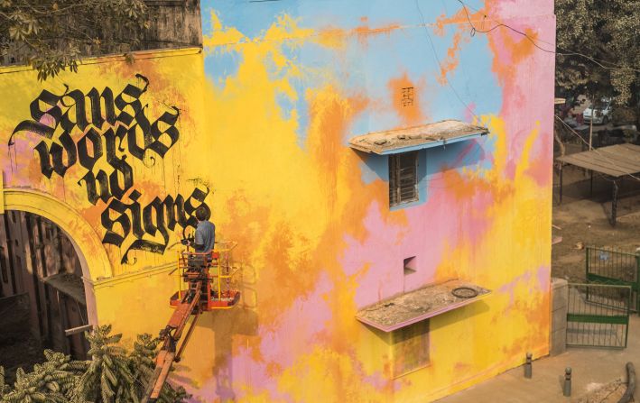 Street artist, Shoe, from the Netherlands is known for "calligraffiti" -- a fusion of calligraphy and graffiti. For St+rt Delhi, he did something he has never done before -- painting a poem he'd written himself. <em>(Photograph by Akshat Nauriyal)</em>