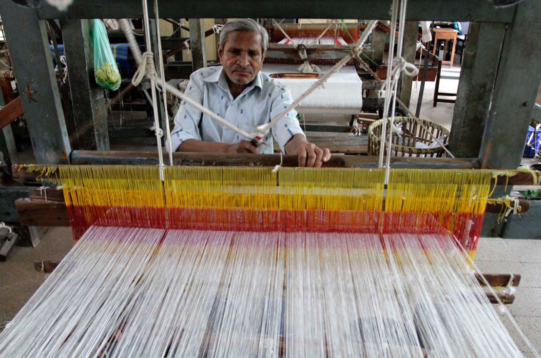 An Indian man weaves cloth at a handloom factory in Ahmadabad, India.