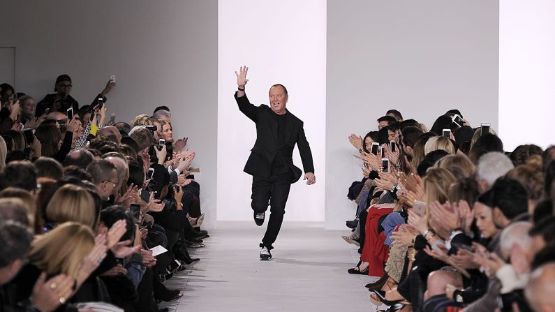 Fashion designer Michael Kors makes an energetic entrance  onto the runway at his line's fall/winter 2016 show. Kors' company, launched in 1981, makes a wide range of men's and women's clothes, accessories, footwear, watches, jewelry, eyewear and fragrances.