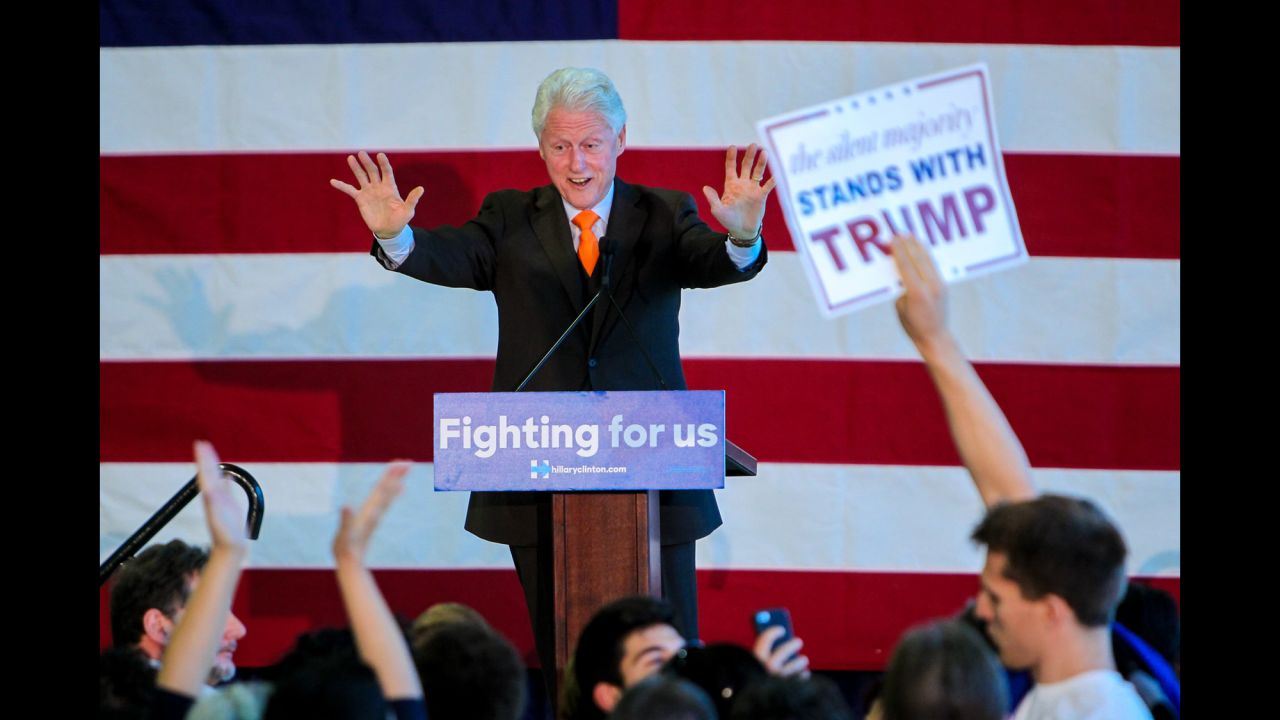 A Donald Trump supporter holds up a sign as former U.S. President Bill Clinton stumps for his wife in Riviera Beach, Florida, on Monday, February 15. The Trump supporter yelled to Clinton, "You took his money!" meaning Trump. "I certainly did," Clinton responded. "I took his money for my foundation, where I used it better than he's using it now."