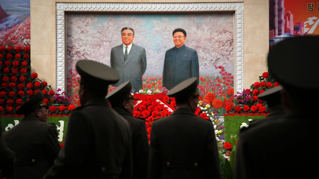 Military soldiers in Pyongyang, North Korea, walk past a mural of the late North Korean leaders Kim Il Sung and Kim Jong Il on Monday, February 15. The country was marking the birthday of Kim Jong Il, who would have been 74 on February 16.