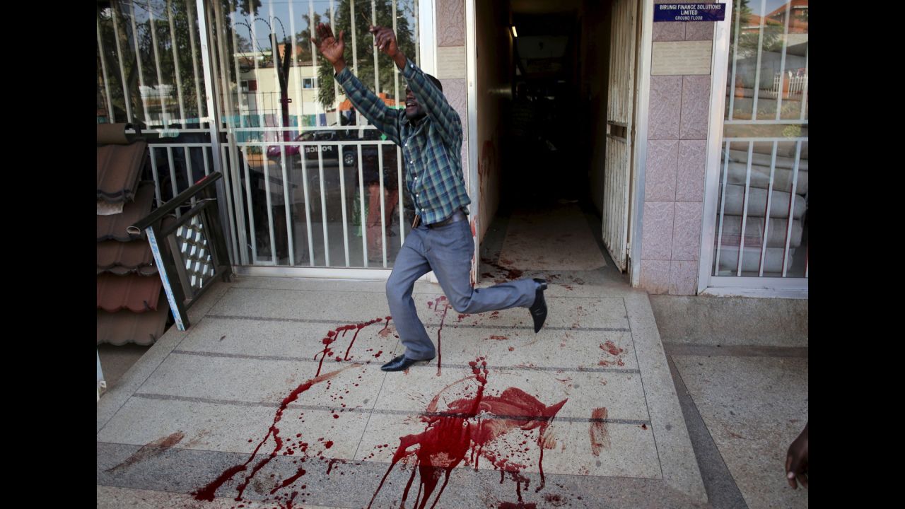 A man gestures after seeing a dead protester in Kampala, Uganda, on Monday, February 15. Violence broke out in Kampala ahead of the country's presidential election.