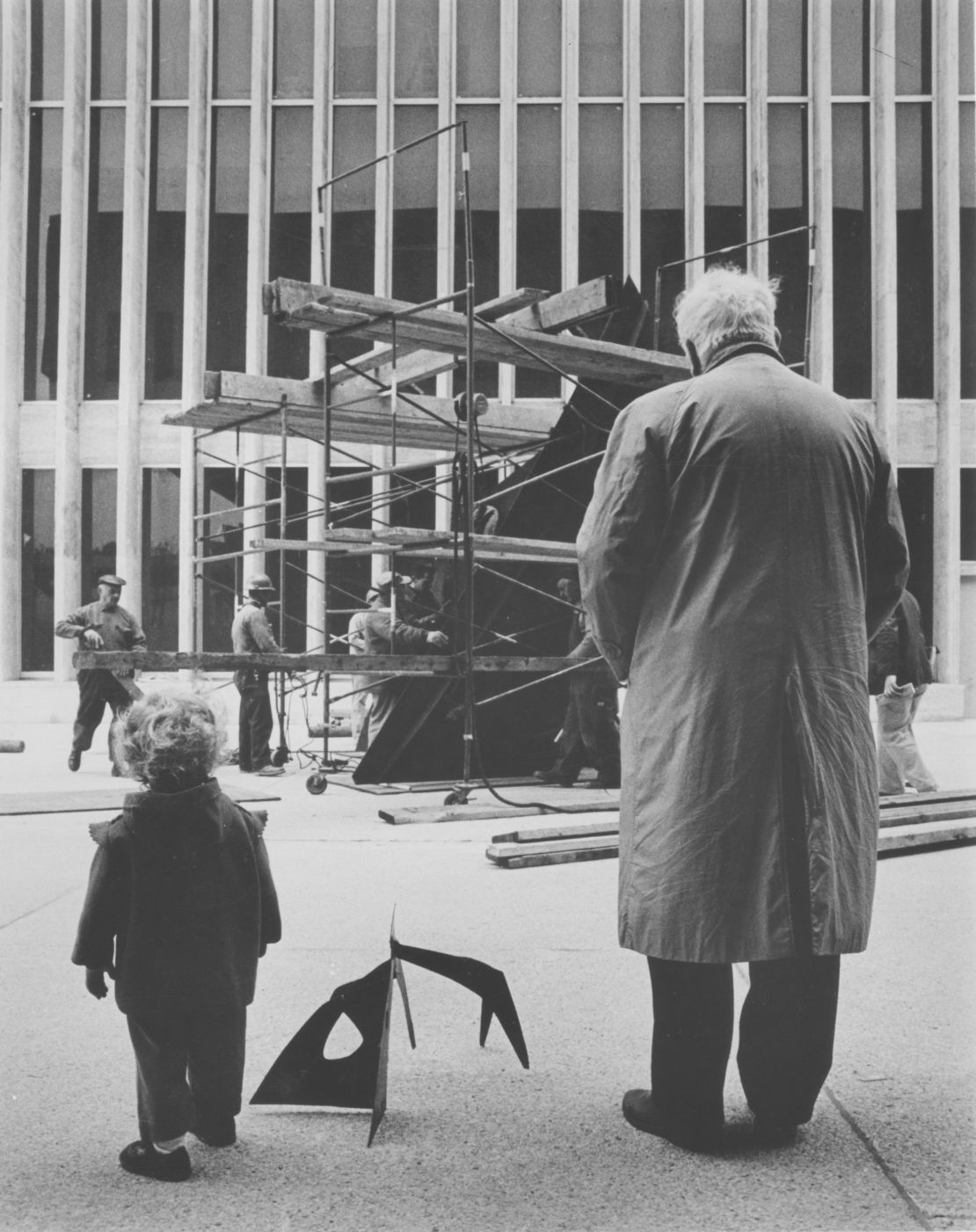 Alexander Calder installing Le Guichet (1963) with grandson Alexander S. C. Rower at Lincoln Center in New York, 1965.