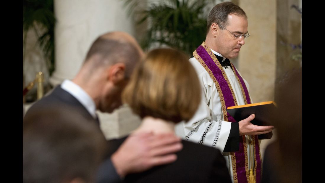 Scalia's son Paul, a Catholic priest, leads a prayer for his father during the private ceremony at the Supreme Court.