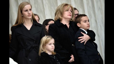 Family members watch as Scalia's casket is carried up the steps of the Supreme Court building on February 19.