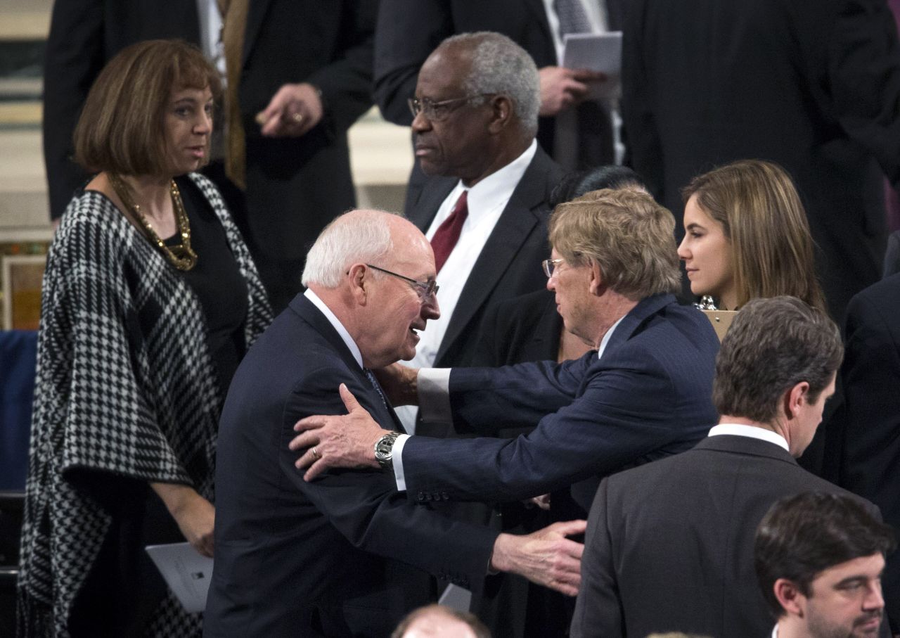 Former Vice President Dick Cheney, left, and Supreme Court Justice Clarence Thomas take their seats for the funeral Mass on February 20.