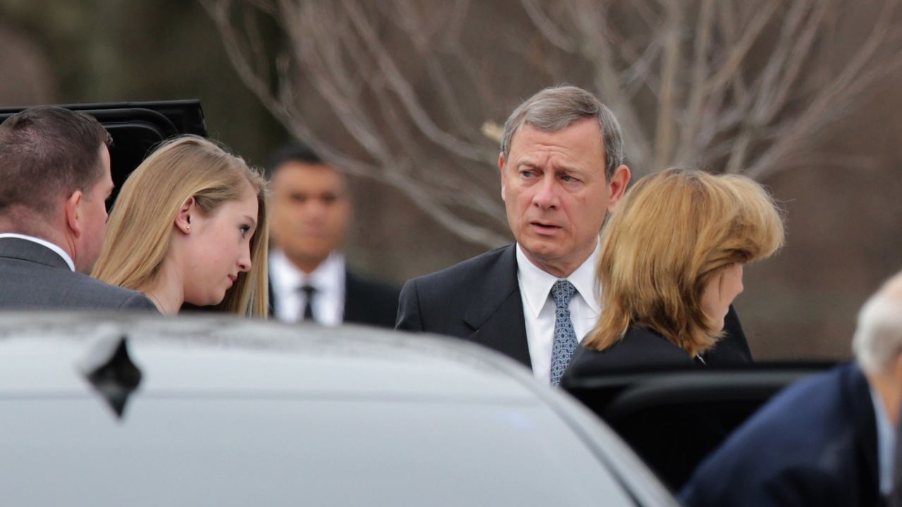 Chief Justice John Roberts, his wife, Jane Roberts, and daughter Josie Roberts arrive for the funeral on February 20.