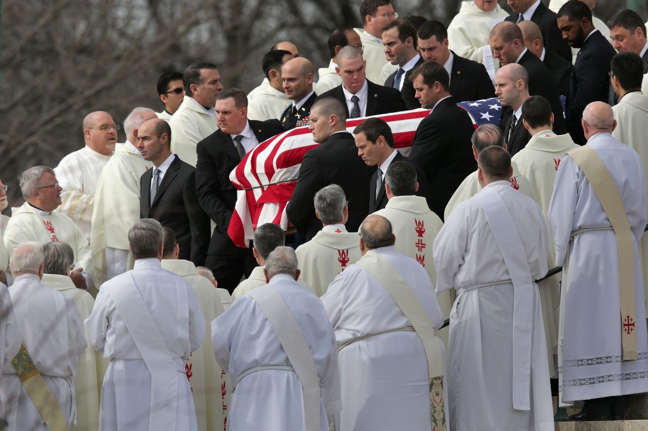 U.S. Supreme Court Police pallbearers carry Associate Justice Antonin Scalia's flag-covered casket between rows of Catholic clergy and out of the Basilica of the National Shrine of the Immaculate Conception after his funeral on Saturday, February 20, in Washington.