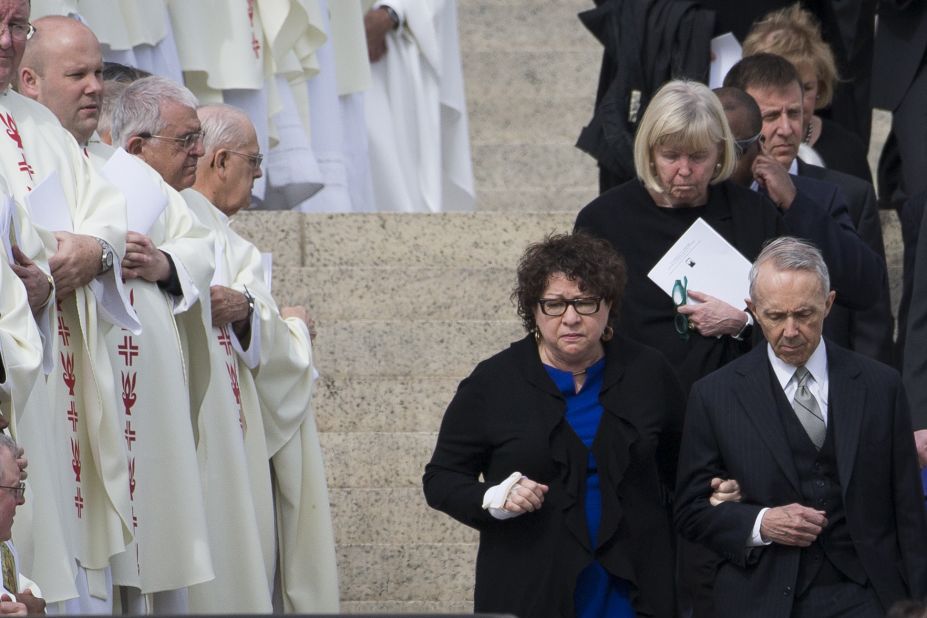 Supreme Court Justice Sonia Sotomayor, center, and former Justice David Souter, right, walk down the steps of the Basilica of the National Shrine of the Immaculate Conception at the end of the funeral.