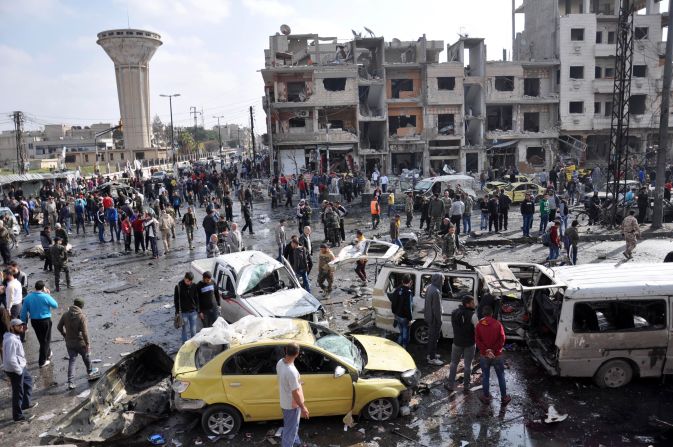 Syrians gather at the site of a double car bomb attack in the Al-Zahraa neighborhood of the Homs, Syria, on February 21, 2016. <a href="index.php?page=&url=http%3A%2F%2Fwww.cnn.com%2F2016%2F02%2F21%2Fmiddleeast%2Fsyria-civil-war%2Findex.html" target="_blank">Multiple attacks in Homs and southern Damascus</a> kill at least 122 and injure scores, according to the state-run SANA news agency. ISIS claimed responsibility.