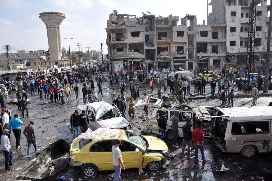 Syrians gather at the site of a double car bomb attack in the Al-Zahraa neighborhood of the Homs, Syria, on February 21, 2016. <a href="http://www.cnn.com/2016/02/21/middleeast/syria-civil-war/index.html" target="_blank">Multiple attacks in Homs and southern Damascus</a> kill at least 122 and injure scores, according to the state-run SANA news agency. ISIS claimed responsibility.
