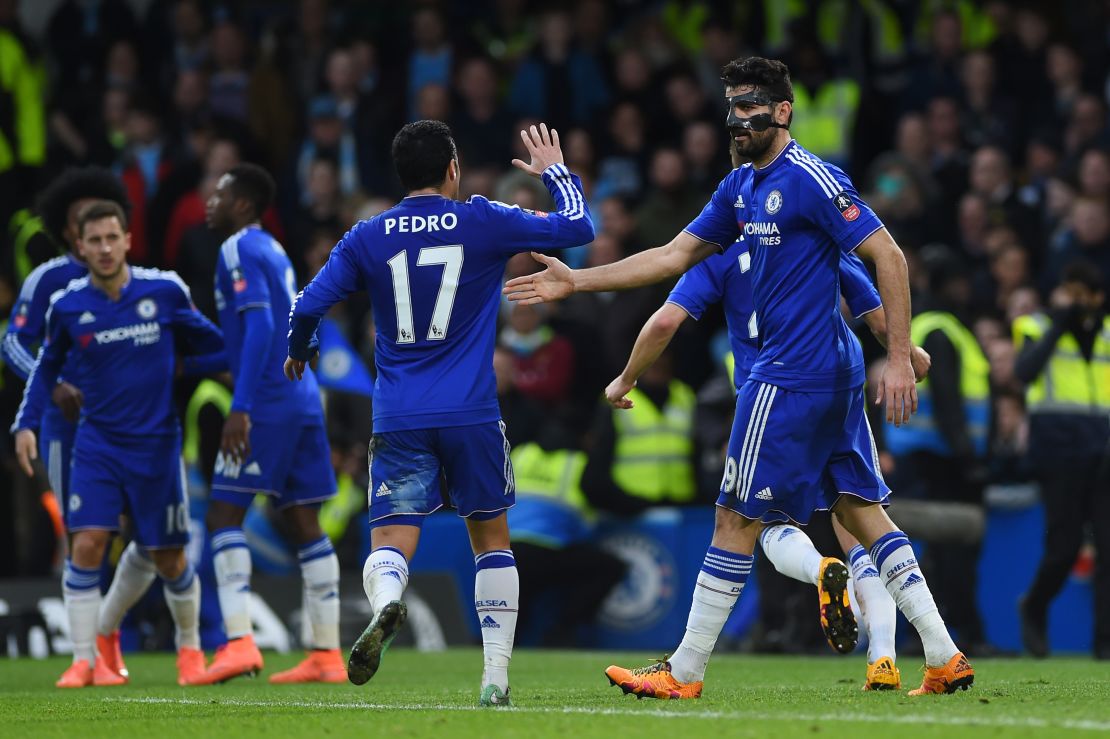 The masked Diego Costa celebrates with teammate Pedro after scoring the opener in Chelsea's 5-1 win over Manchester City in the FA Cup. 