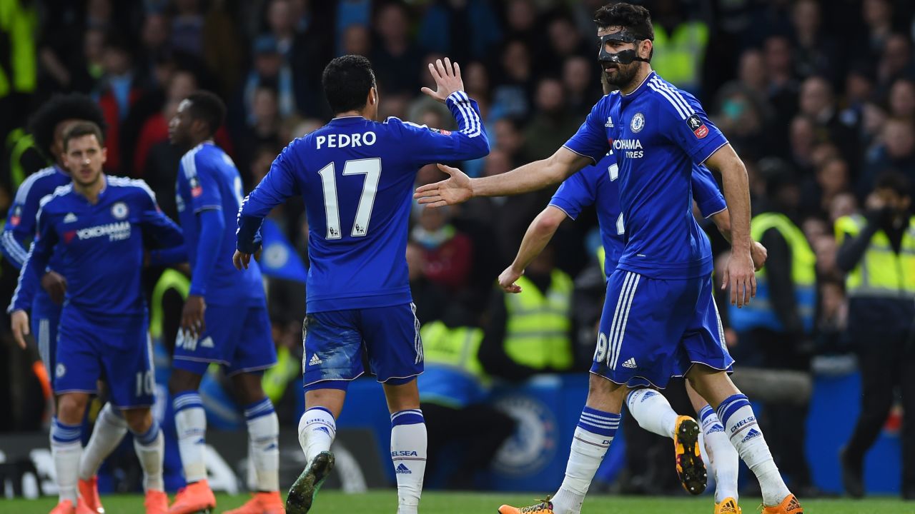 The masked Diego Costa celebrates with teammate Pedro after scoring the opener in Chelsea's 5-1 win over Manchester City in the FA Cup. 