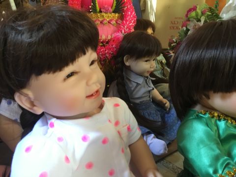The dolls have been blessed by monks who match the right doll to the right parent. Their "birthday" is selected on a date auspicious for the parent.