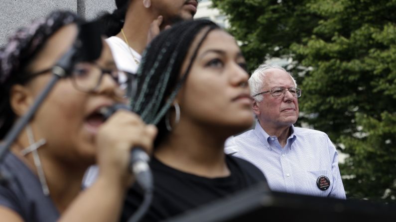 Seconds after Sanders took the stage for a campaign rally in August 2015, a dozen protesters from Seattle's Black Lives Matter chapter <a href="index.php?page=&url=http%3A%2F%2Fwww.cnn.com%2F2015%2F08%2F08%2Fpolitics%2Fbernie-sanders-black-lives-matter-protesters%2Findex.html" target="_blank">jumped barricades and grabbed the microphone</a> from the senator. Holding a banner that said "Smash Racism," two of the protesters -- Marissa Johnson, left, and Mara Jacqueline Willaford -- began to address the crowd.