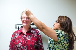 Eileen Bachemin, 50, gets her height measured during a physical exam.