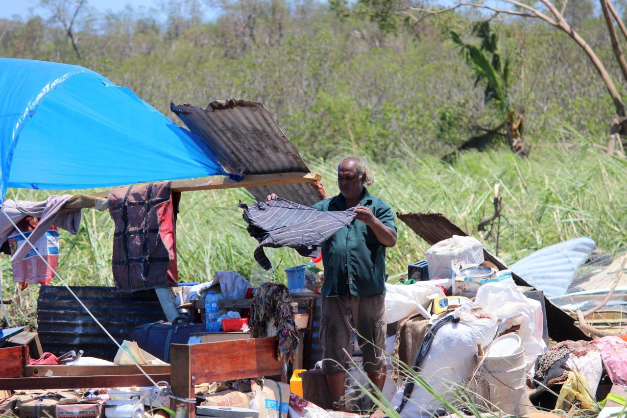 A Ba resident dries his belongings, in an image released by the Fiji government, February 22. 