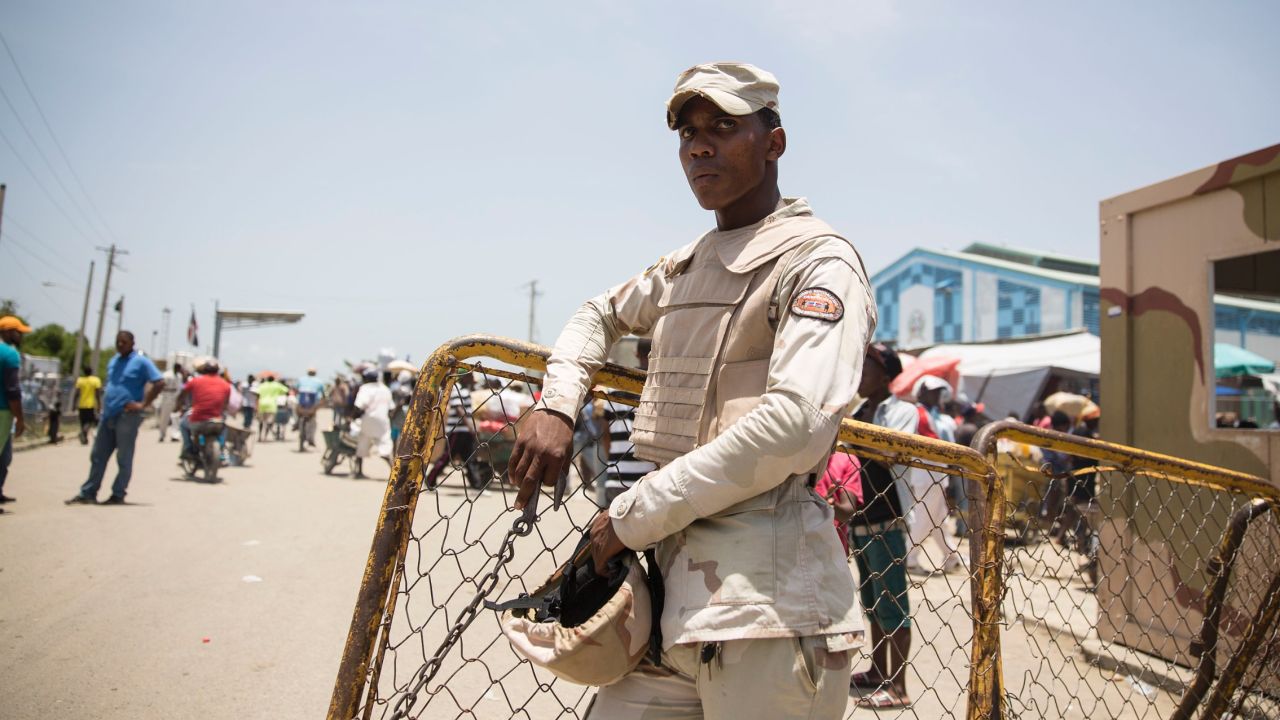 A Dominican soldier stands guard near the Dominican-Haitian border.