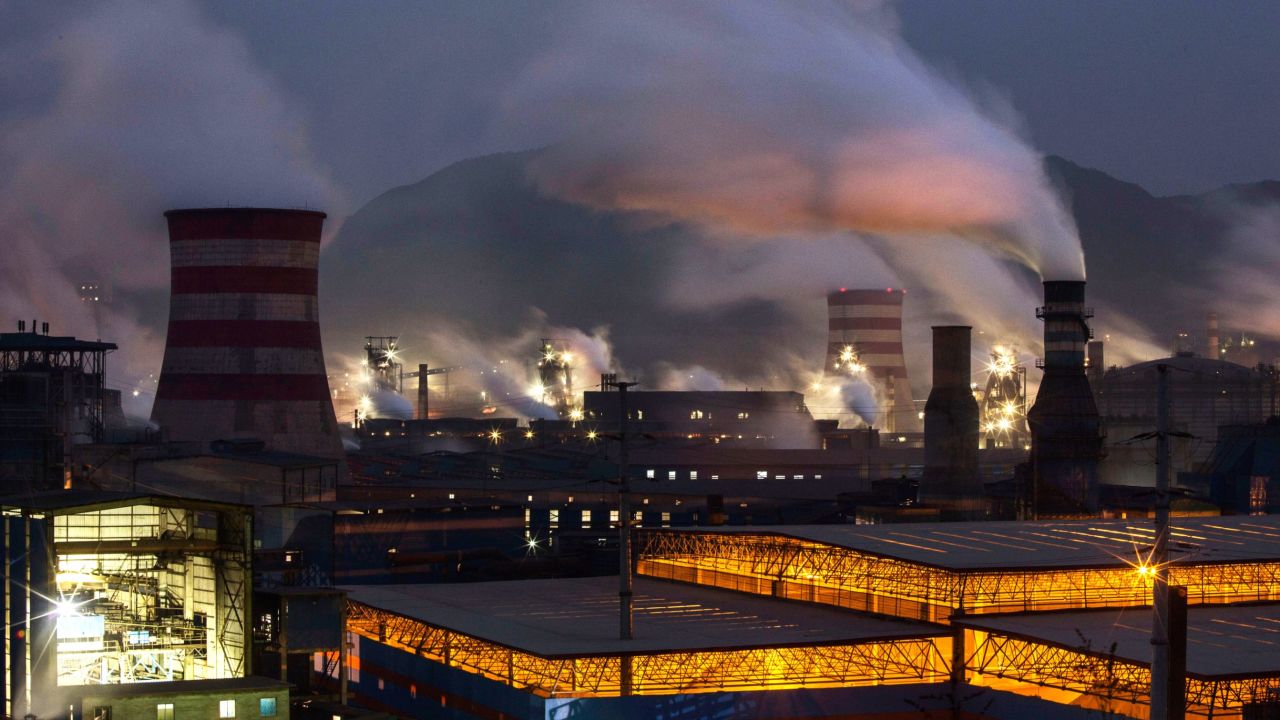 Smoke billows from smokestacks and a coal-fired generator at a steel factory in China's Hebei province.