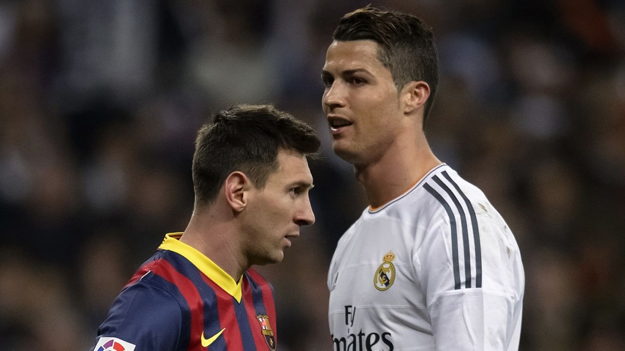 Barcelona's Argentinian forward Lionel Messi (L) stands past Real Madrid's Portuguese forward Cristiano Ronaldo during the "El clasico" Spanish League football match Real Madrid vs Barcelona at the Santiago Bernabeu stadium in Madrid on March 23, 2014. Barcelona won 4-3.    AFP PHOTO/ DANI POZO        (Photo credit should read DANI POZO/AFP/Getty Images)