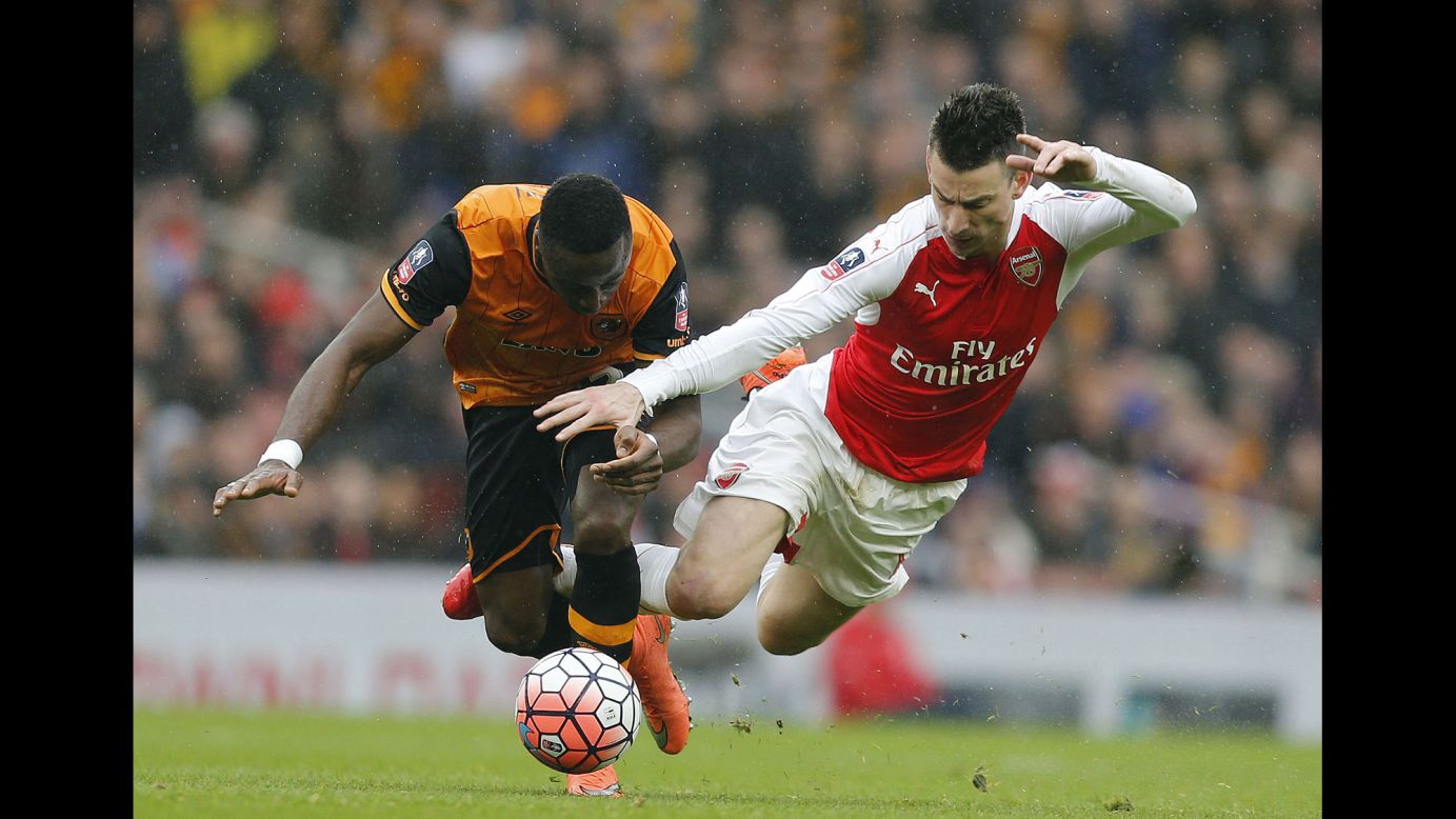 Hull City's Adama Diomande, left, competes for the ball with Arsenal's Laurent Koscielny during an FA Cup match in London on Saturday, February 20. The match ended scoreless.