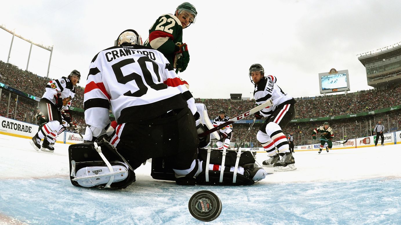 The puck gets past Chicago goalie Corey Crawford during an NHL game in Minneapolis on Sunday, February 21. The game was played at the University of Minnesota's football stadium as part of the league's Stadium Series. The home team Wild won 6-1.