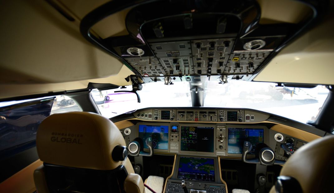 The Vision flight deck is one of the highlights on Global 6000. Its head-up display (the pink glass in the top left) projects important flight data for pilots. Its enhanced vision system replicates the terrain outside in conditions with little or no visibility. 