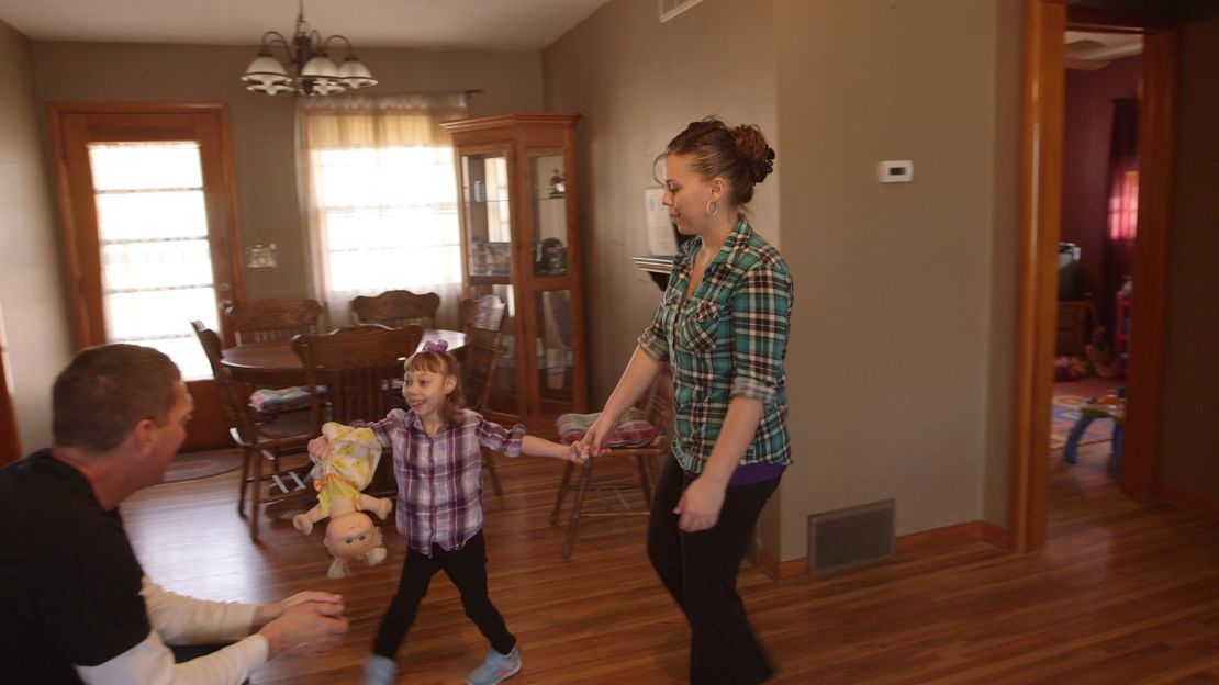 Anika Aramburu plays with her mother, Angelina, and her father, Jesse Carter. 