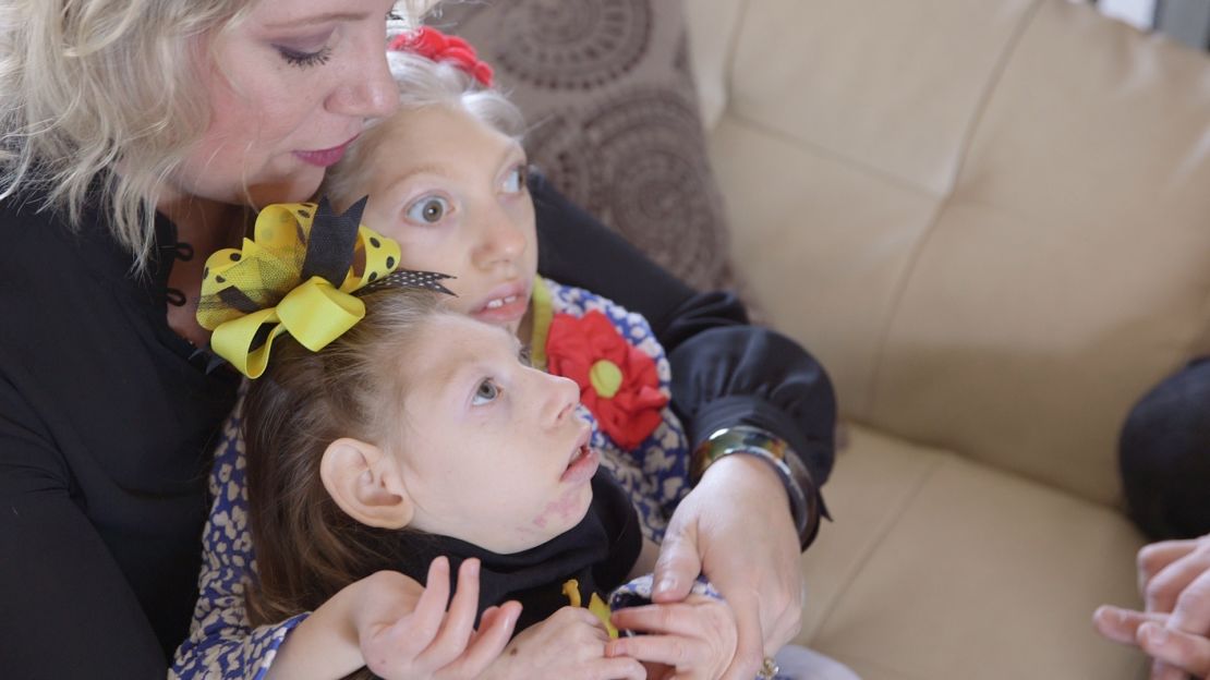 Gwen Hartley cuddles her daughters, Claire and Lola. 