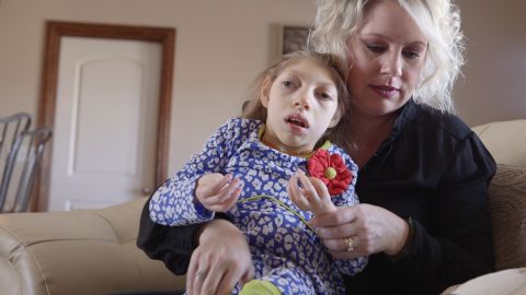Gwen Hartley holds her daughter Claire, who has microcephaly.