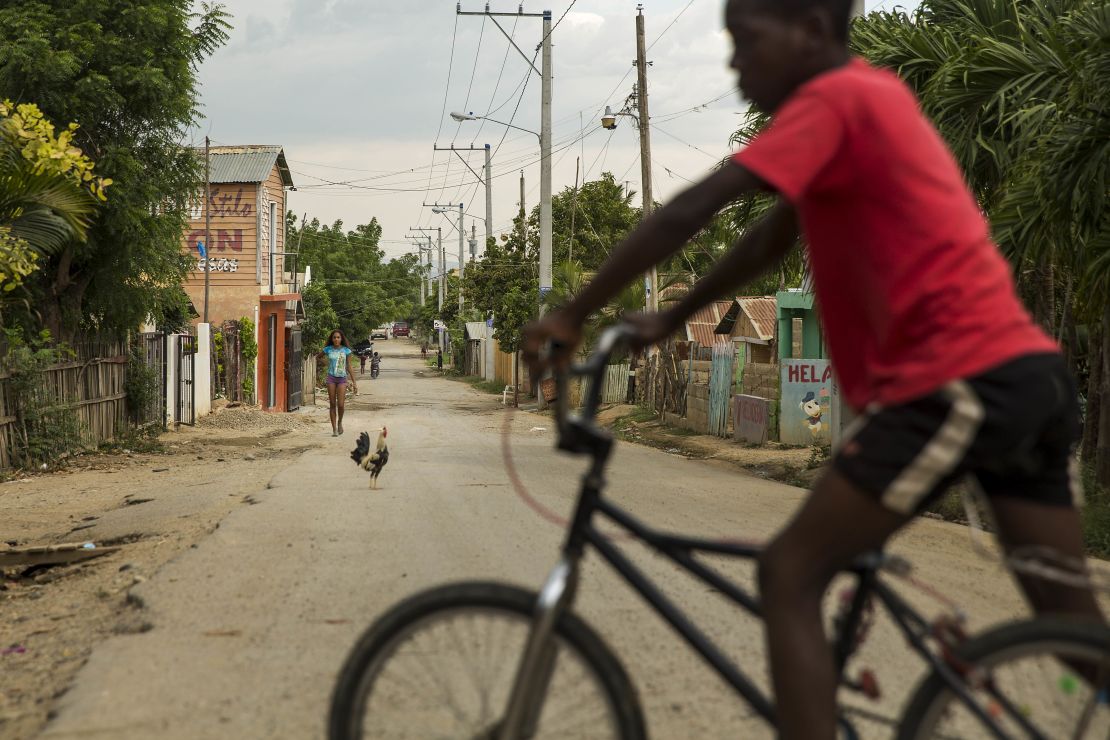A Dominican boy of Haitian descent rides his bike in Esperanza, Dominican Republic, in July 2015. Dominicans in this segment of the population are fighting for equal rights.