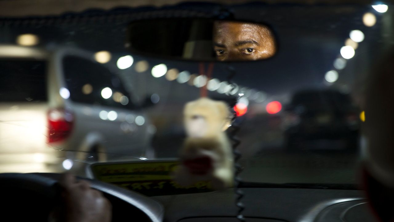 A Dominican taxi driver contends with Santo Domingo traffic. Immigration seemed to be on everyone's mind.