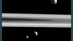 NASA has released a stunning image showing three of Saturn's moons and the planet's iconic rings. Tethys, Enceladus and Mimas were captured in the same shot by the Cassini spacecraft, which has studied the planet and its natural satellites since 2004. 
