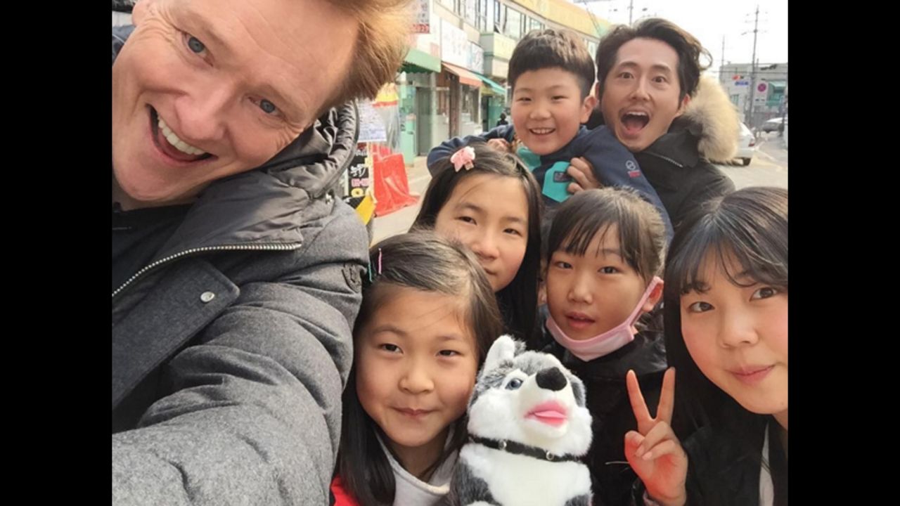 Talk-show host Conan O'Brien takes a selfie with actor Steven Yeun and some children in Seoul, South Korea, on Thursday, February 18. "#StevenYeun & I won a stuffed animal out of a vending machine and gave it to this little girl. Everyone wins. #ILoveSeoul," <a href="https://www.instagram.com/p/BB8Na2YjQQM/?taken-by=teamcoco" target="_blank" target="_blank">O'Brien said on Instagram.</a>