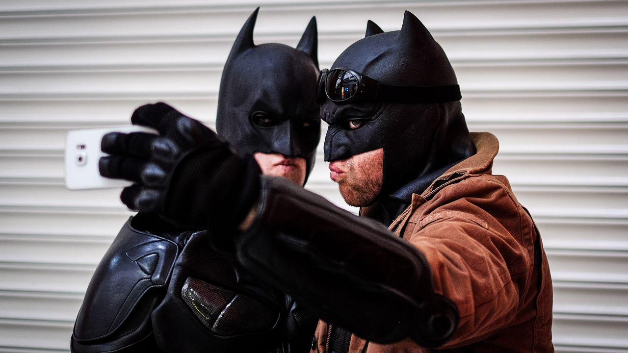 A couple of men dressed as Batman take a selfie at a comic convention in London on Sunday, February 21.