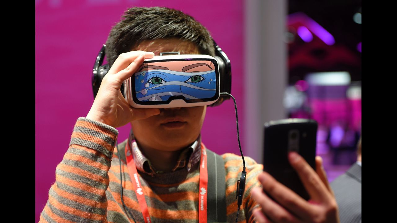 A boy takes a selfie as he tests the Oculus VR, a virtual reality headset, in Barcelona, Spain, on Monday, February 22. It was the first day of the Mobile World Congress.