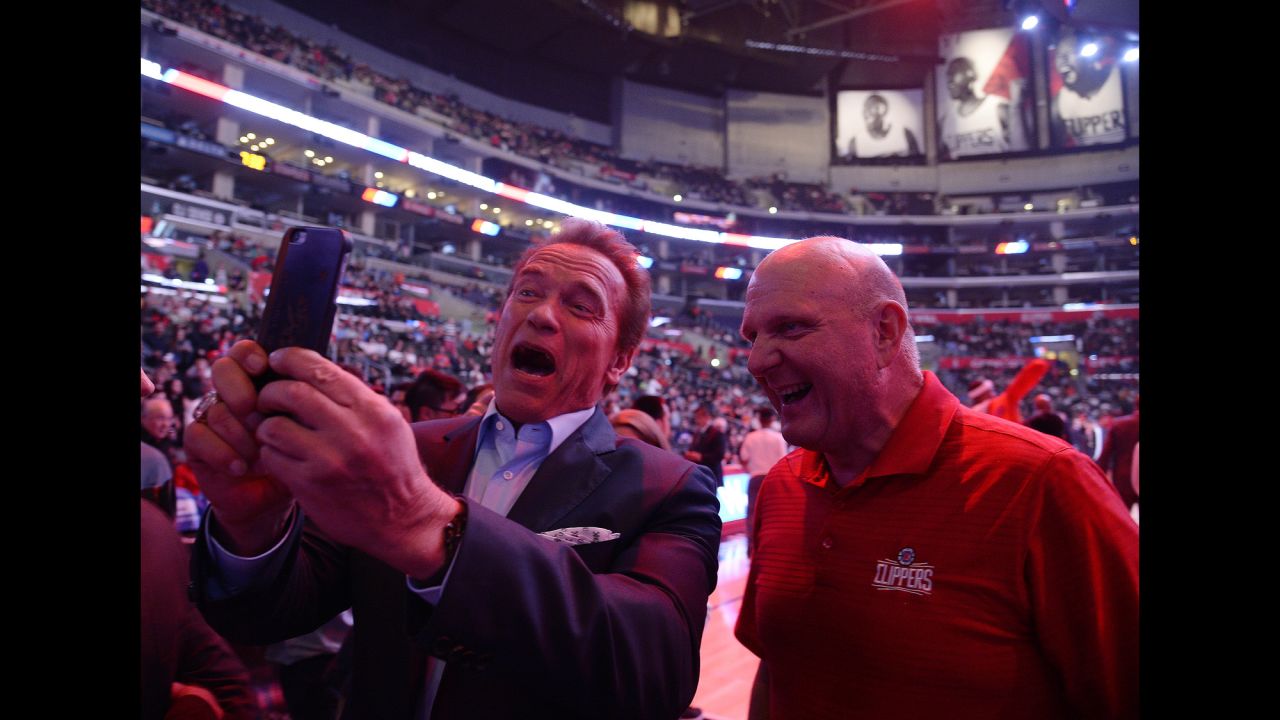 Actor Arnold Schwarzenegger takes a selfie with Los Angeles Clippers owner Steve Ballmer during an NBA basketball game on Monday, February 22.