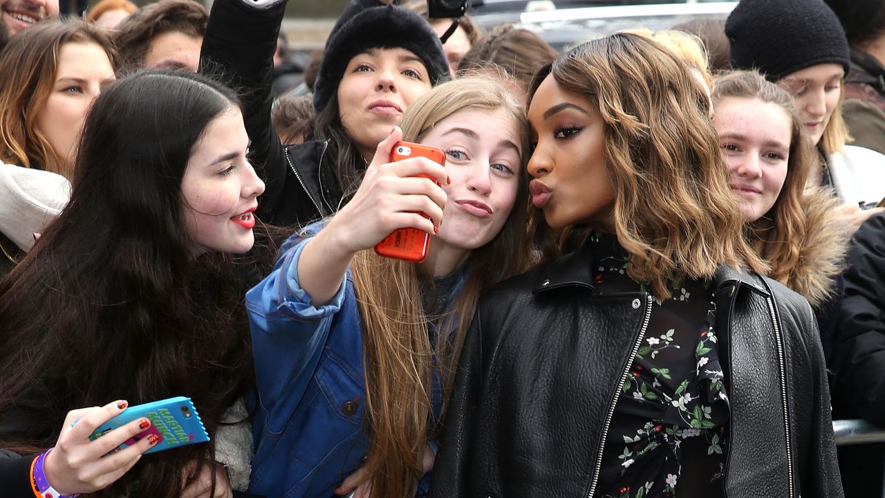 Model Jourdan Dunn poses for a fan's selfie during a fashion show in London on Sunday, February 21.