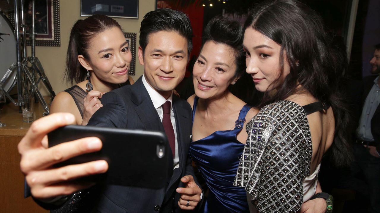 From left, actors JuJu Chan, Harry Shum Jr., Michelle Yeoh and Natasha Liu Bordizzo take a photo together Monday, February 22, after the premiere of their film "Crouching Tiger, Hidden Dragon: Sword of Destiny."
