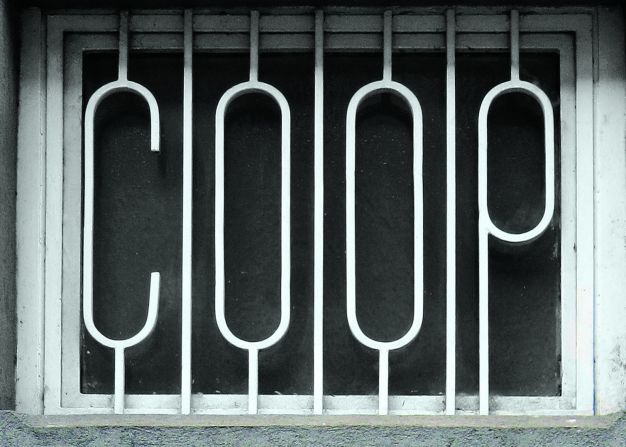 Iron bars with letters protecting a window on an office in Milan.