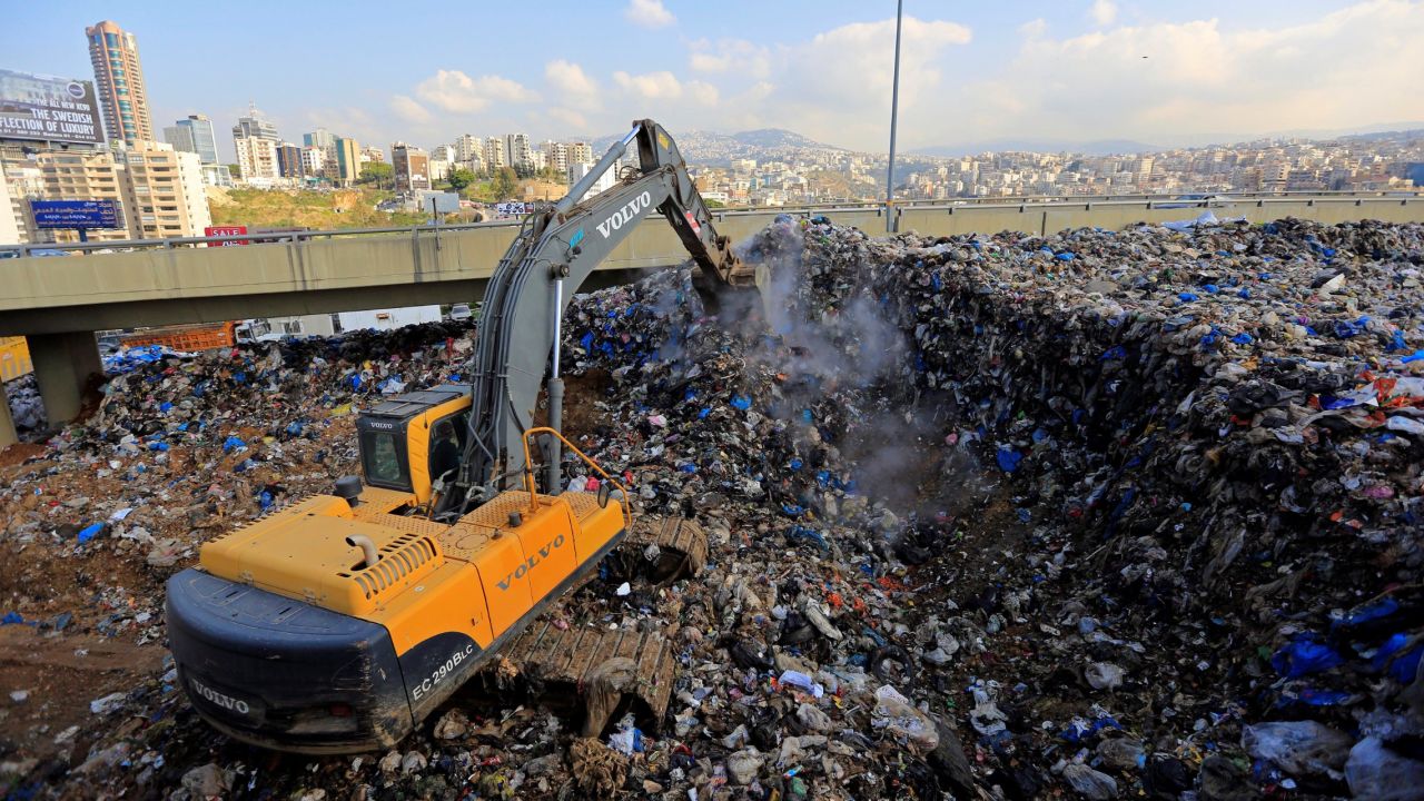 Workers arrange piles of garbage in the Hazimiye neighborhood of Beirut on February 3.